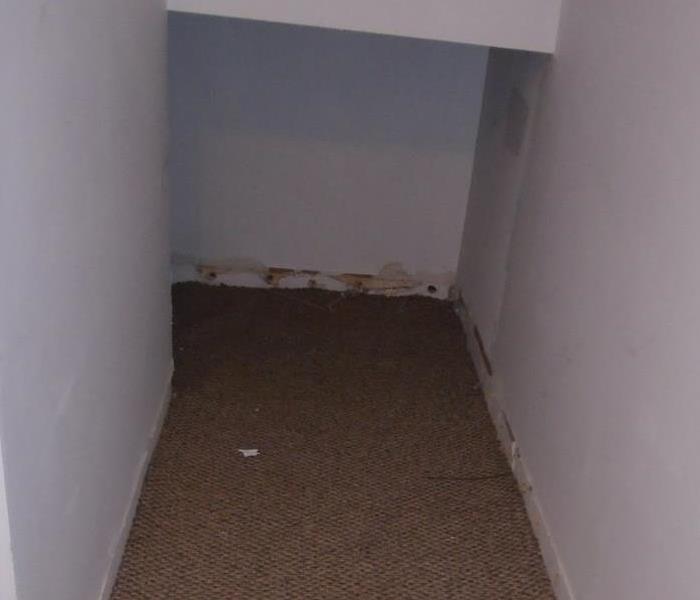 Water damage under apartment stairs