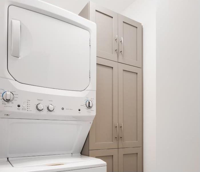 A stacked washer and dryer system
